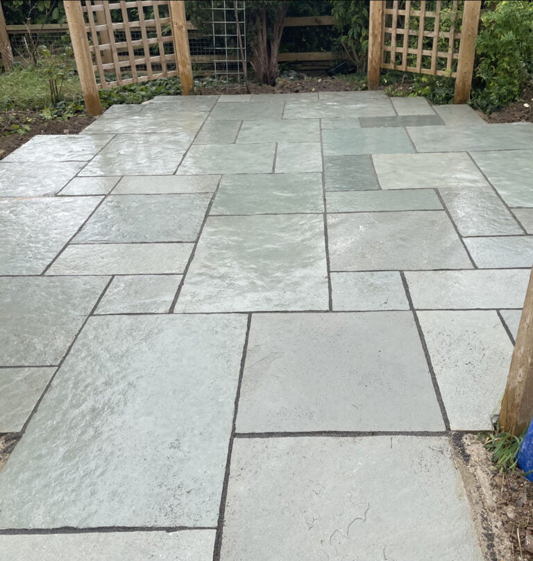 Newly laid patio with grey slabs.
