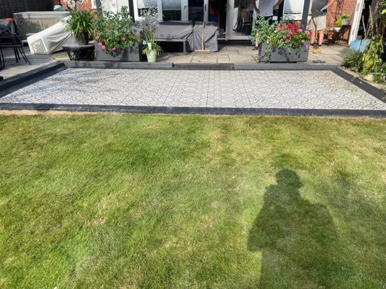 Garden with tiled patio and flowers