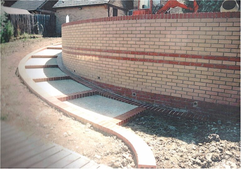 Curved brick retaining wall under construction