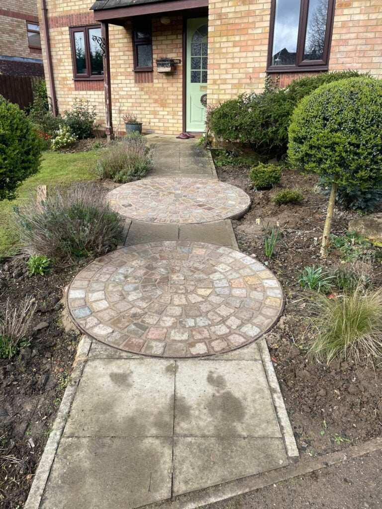 Front garden with circular stone path to door.