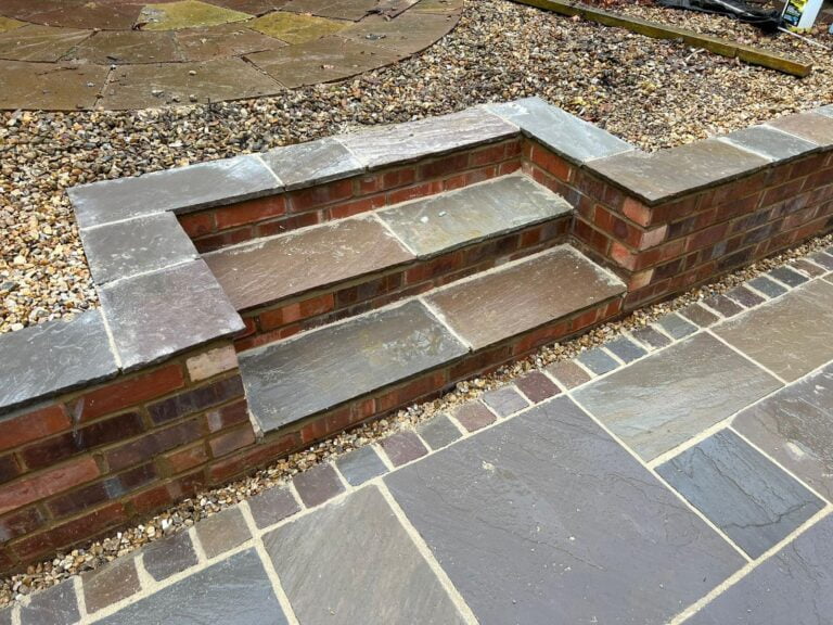 Brick and stone garden steps with gravel surroundings.