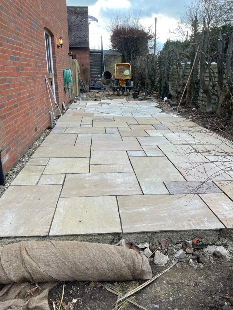 Newly laid outdoor patio with cement mixer.